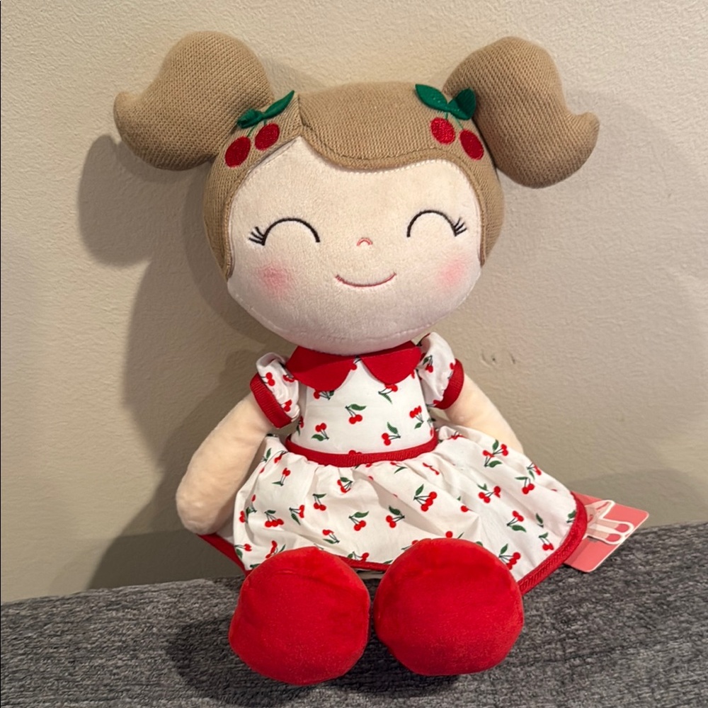 Red and White Stuffed Animal with Floral Dress
